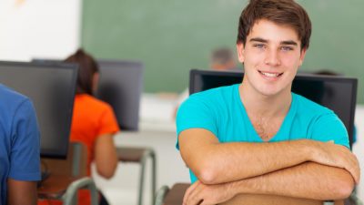 student in class handsome male college student in computer class