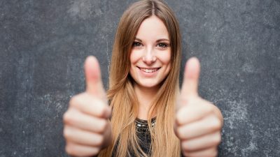 Teenage girl showing thumbs up Teenage girl showing thumbs up with both hands
