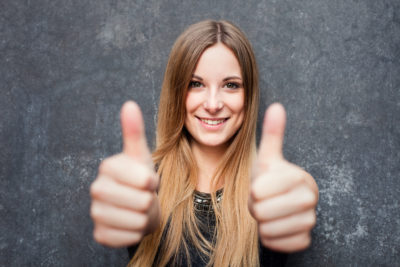 Teenage girl showing thumbs up Teenage girl showing thumbs up with both hands
